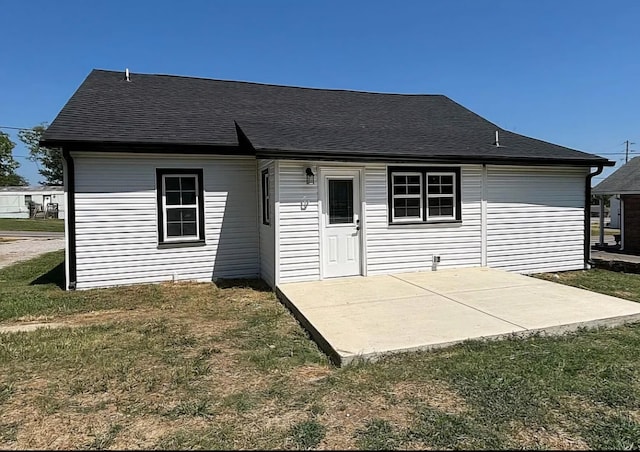 back of property featuring a patio and a yard