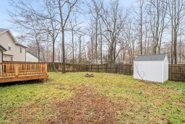 view of yard featuring a deck and a storage unit