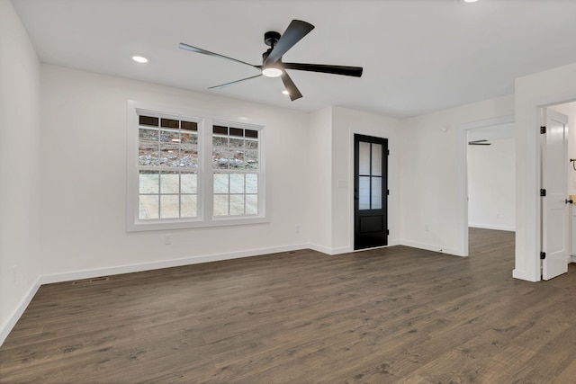 empty room with ceiling fan and dark hardwood / wood-style floors