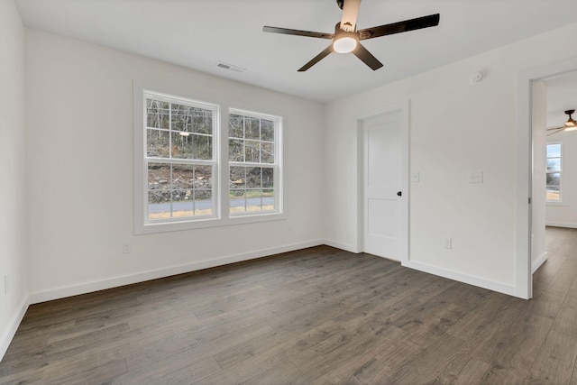 unfurnished bedroom with dark hardwood / wood-style flooring, multiple windows, and ceiling fan