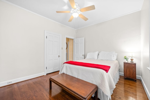 bedroom with crown molding, hardwood / wood-style flooring, and ceiling fan