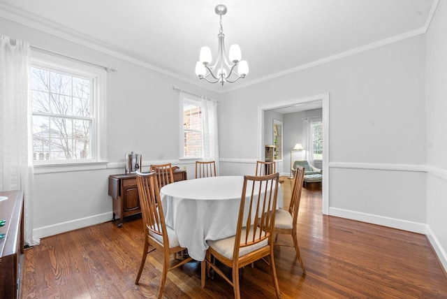 dining area featuring a notable chandelier, a wealth of natural light, dark wood-type flooring, and ornamental molding