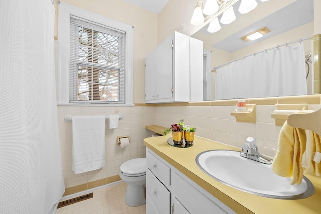 bathroom featuring vanity, tile walls, a shower with shower curtain, and toilet