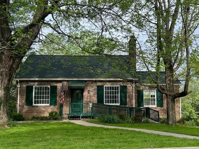 115 Maplemere Dr, Clarksville, TN 37040 - view of front of house with brick siding, a front yard, and a chimney