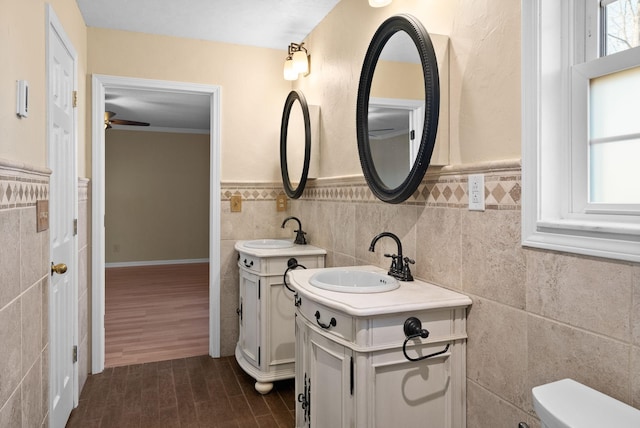 bathroom featuring hardwood / wood-style floors, vanity, tile walls, and toilet