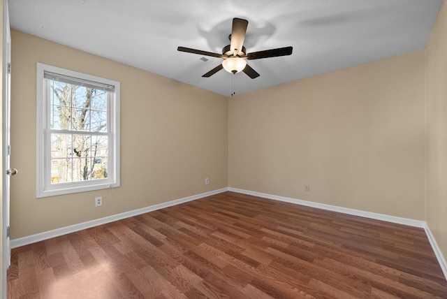 empty room with ceiling fan and hardwood / wood-style floors