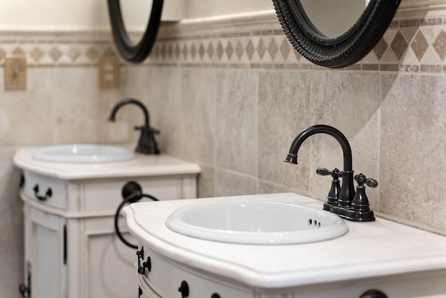 bathroom with vanity and tile walls