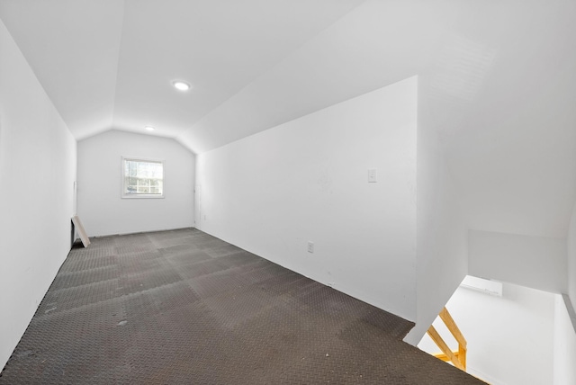 bonus room with carpet floors and vaulted ceiling