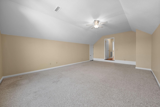 additional living space featuring ceiling fan, lofted ceiling, and carpet