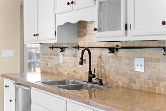 kitchen with white cabinetry, sink, tasteful backsplash, and stainless steel dishwasher