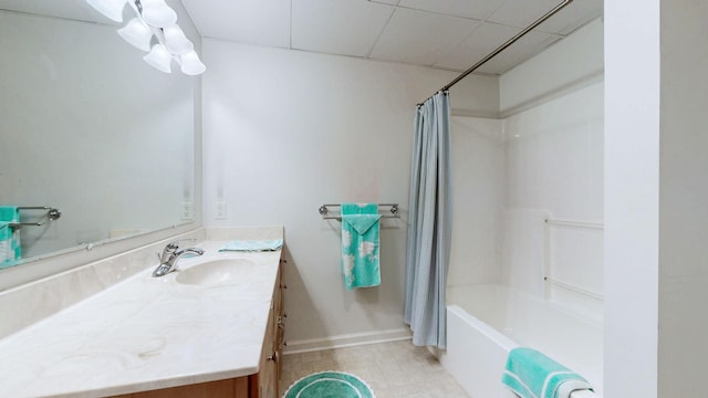 bathroom with baseboards, shower / bath combo, and vanity