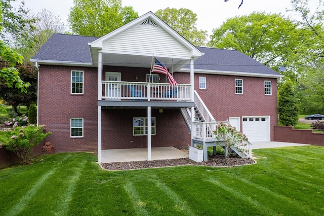 back of house featuring a patio area, stairway, a yard, brick siding, and a garage