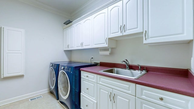 laundry area with crown molding, a sink, visible vents, washer and clothes dryer, and cabinet space