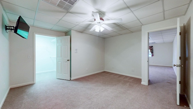 spare room with carpet, visible vents, a ceiling fan, and baseboards