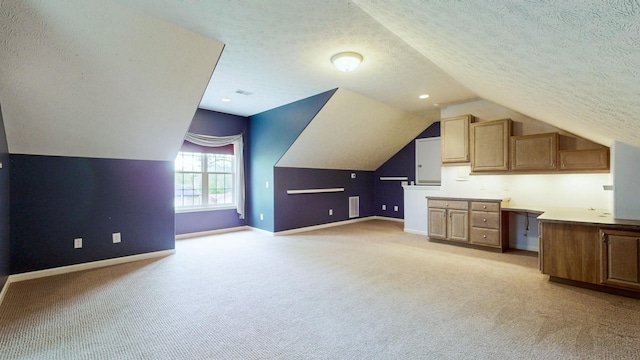 bonus room with baseboards, light carpet, and vaulted ceiling