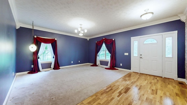 entryway featuring baseboards, ornamental molding, and an inviting chandelier