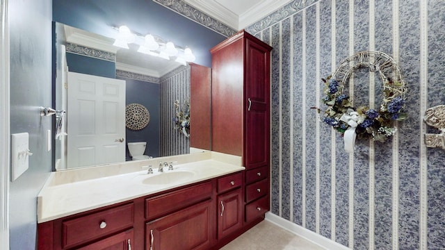 bathroom featuring wallpapered walls, toilet, crown molding, and vanity