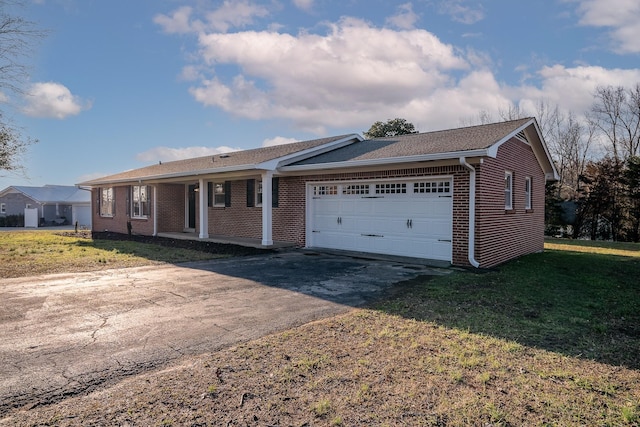 single story home featuring a garage and a front yard