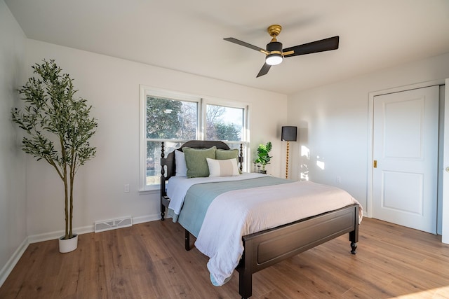 bedroom with ceiling fan and hardwood / wood-style floors