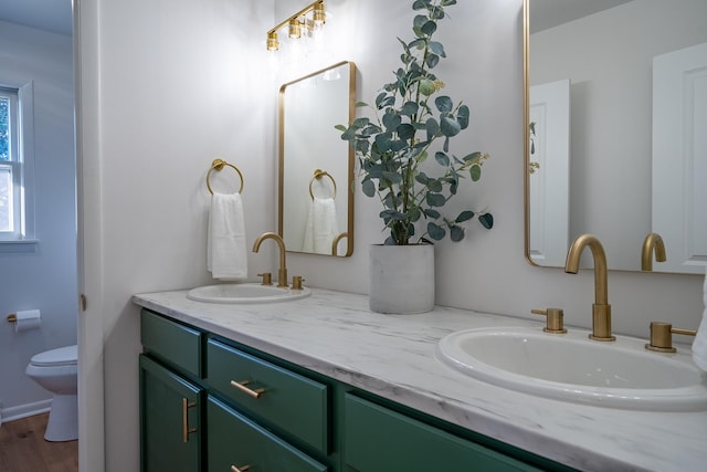 bathroom featuring vanity and toilet