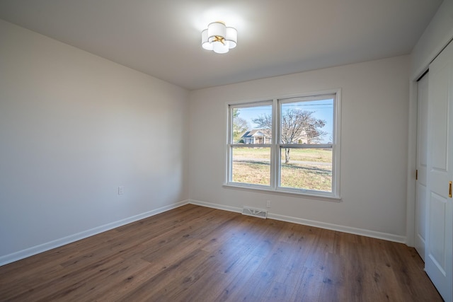 unfurnished room featuring dark hardwood / wood-style floors