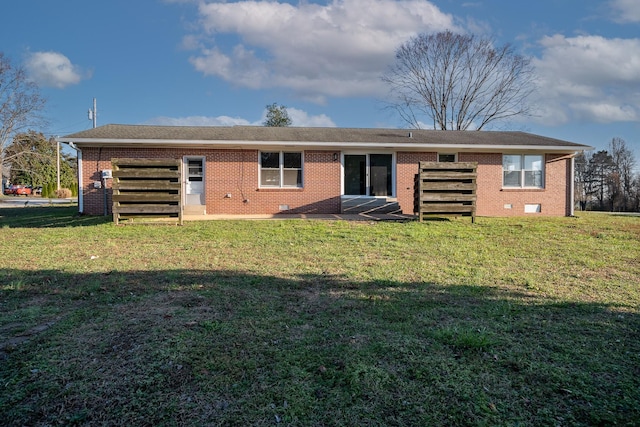 back of property featuring a lawn