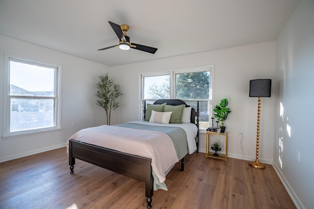 bedroom with hardwood / wood-style flooring and ceiling fan