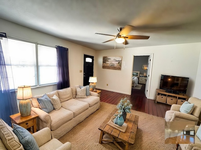 living room with dark wood-type flooring and ceiling fan