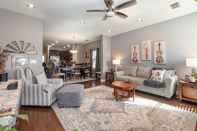 living room featuring dark hardwood / wood-style floors and ceiling fan