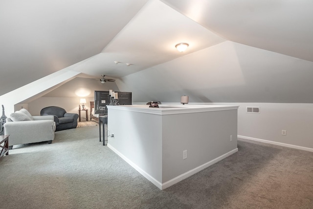 bonus room featuring carpet, lofted ceiling, and ceiling fan