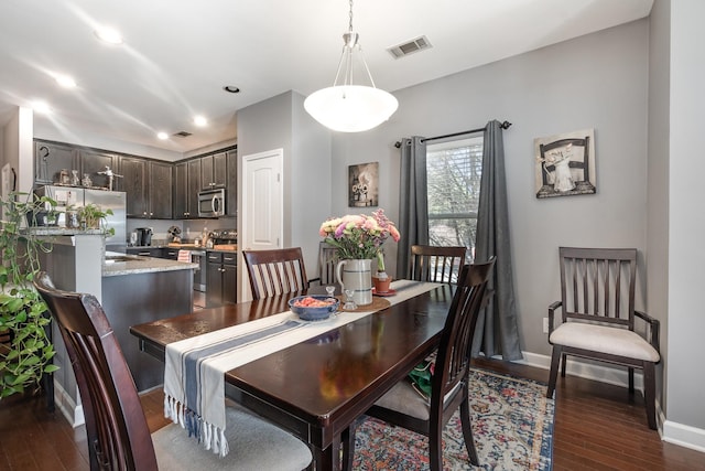 dining space featuring dark wood-type flooring