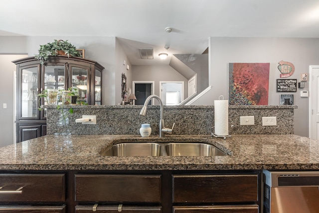 kitchen featuring sink, stainless steel dishwasher, and stone counters