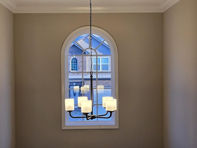 details with crown molding and a chandelier