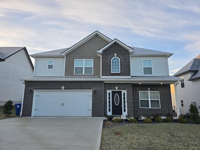 view of front property featuring a garage and a front yard