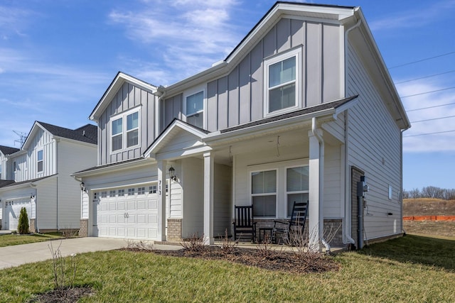 view of front of home with a porch, a garage, and a front lawn