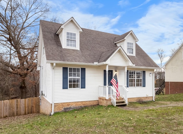 cape cod house featuring a front lawn