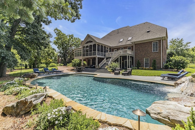 view of swimming pool featuring a patio area and a sunroom