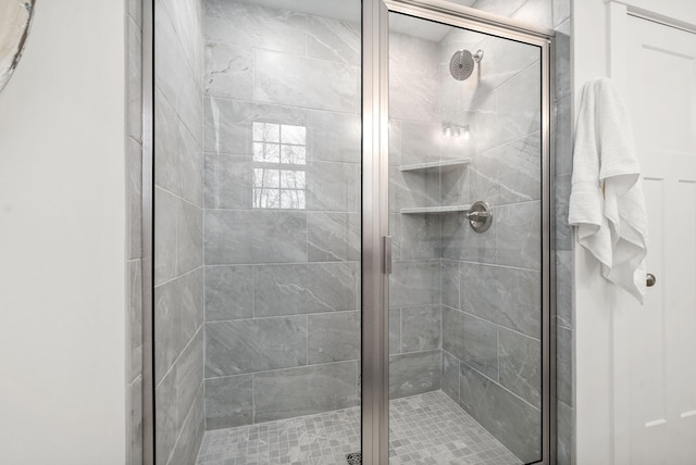 bathroom featuring a shower with door