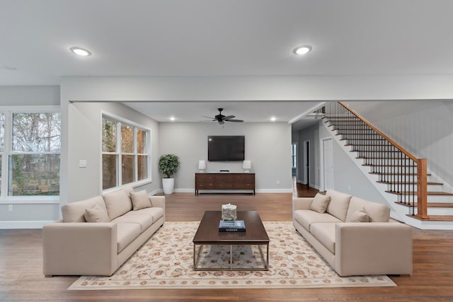 living room with ceiling fan and wood-type flooring