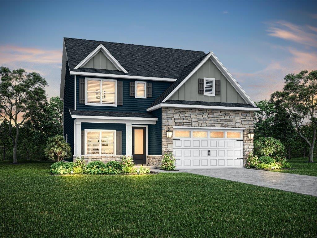 craftsman house featuring a garage and a lawn