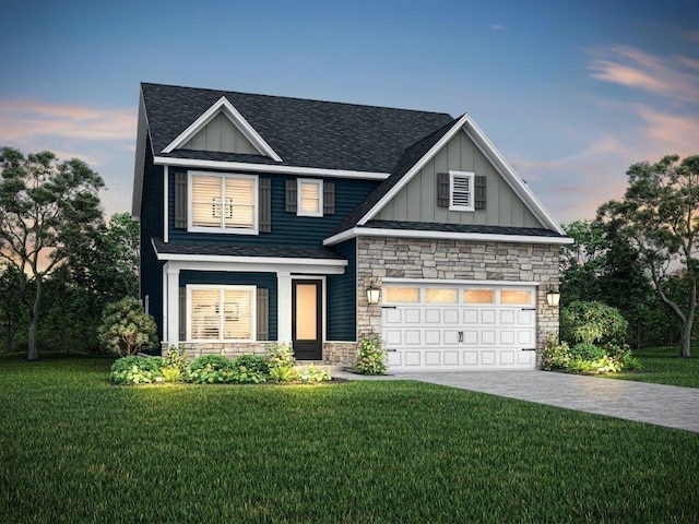 craftsman house featuring a garage and a lawn