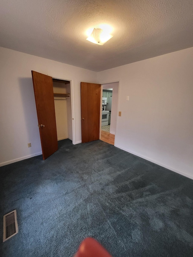 unfurnished bedroom with a closet, baseboards, visible vents, and dark colored carpet