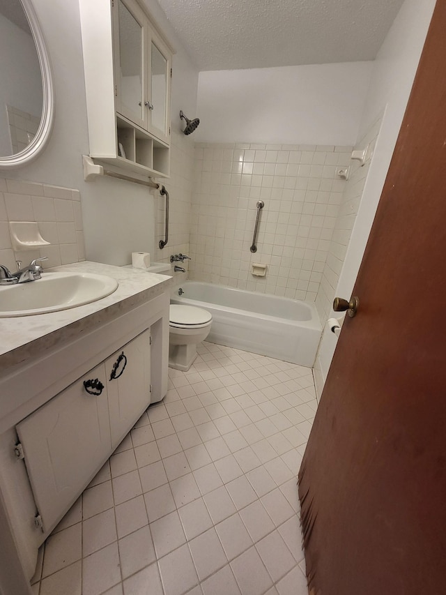 full bath featuring a textured ceiling, tile patterned flooring, vanity, toilet, and  shower combination