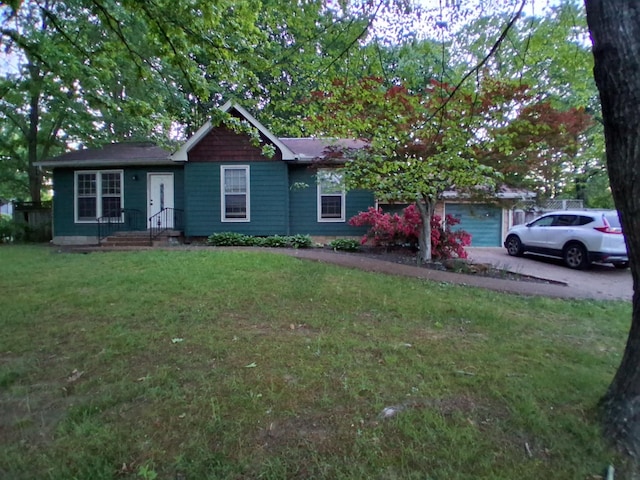 ranch-style house featuring a front lawn and aphalt driveway