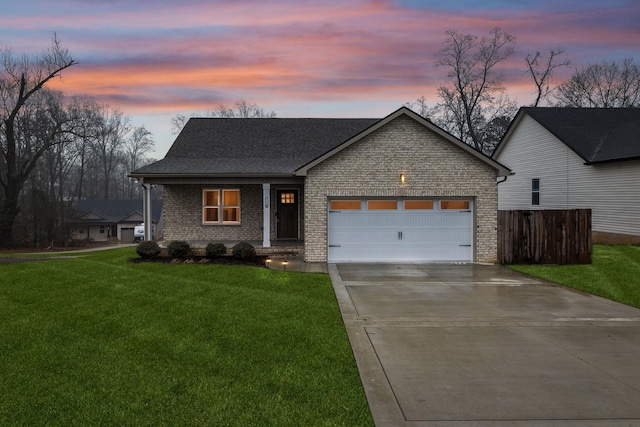 view of front of house featuring a garage and a lawn