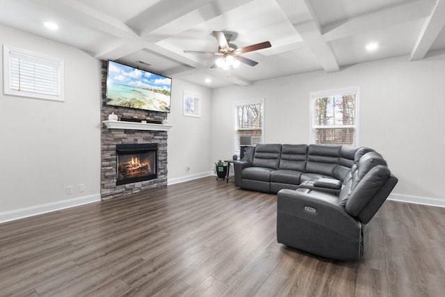 living room featuring coffered ceiling, dark wood-type flooring, a fireplace, and beam ceiling