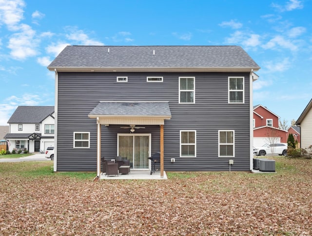 rear view of property featuring cooling unit, ceiling fan, and a patio