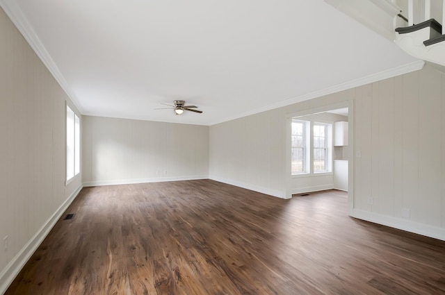 spare room featuring crown molding, dark wood-type flooring, and ceiling fan