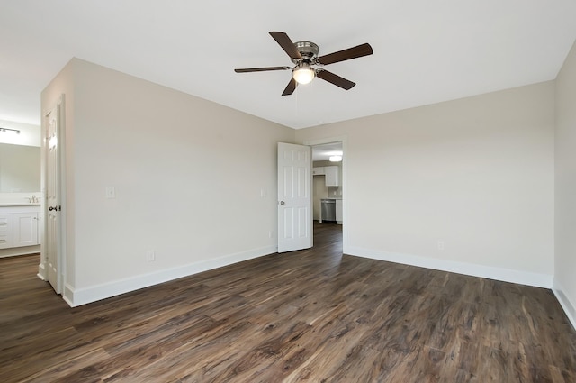 spare room featuring dark wood-type flooring and ceiling fan