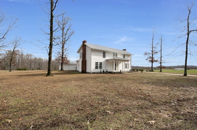 view of front of house with covered porch and a front yard